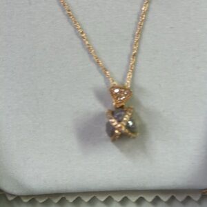 14K gold caged raw diamond necklace.